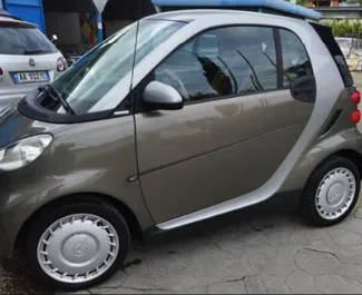 Frontansicht eines Mietwagens Smart Fortwo am Flughafen von Tirana, Albanien ✓ Auto Nr.10011. ✓ Automatisch TM ✓ 0 Bewertungen.