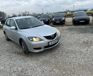 Frontansicht eines Mietwagens Mazda 3 am Flughafen von Tirana, Albanien ✓ Auto Nr.11900. ✓ Schaltgetriebe TM ✓ 0 Bewertungen.